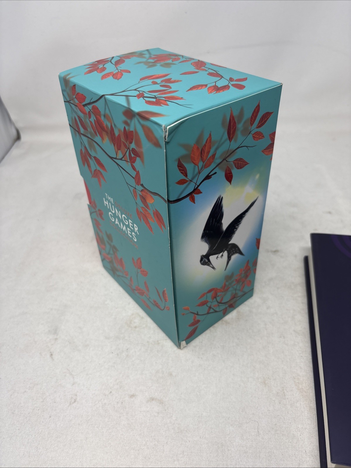 The Deluxe Hunger Games collection paperback + hard cover sunrise on the reaping